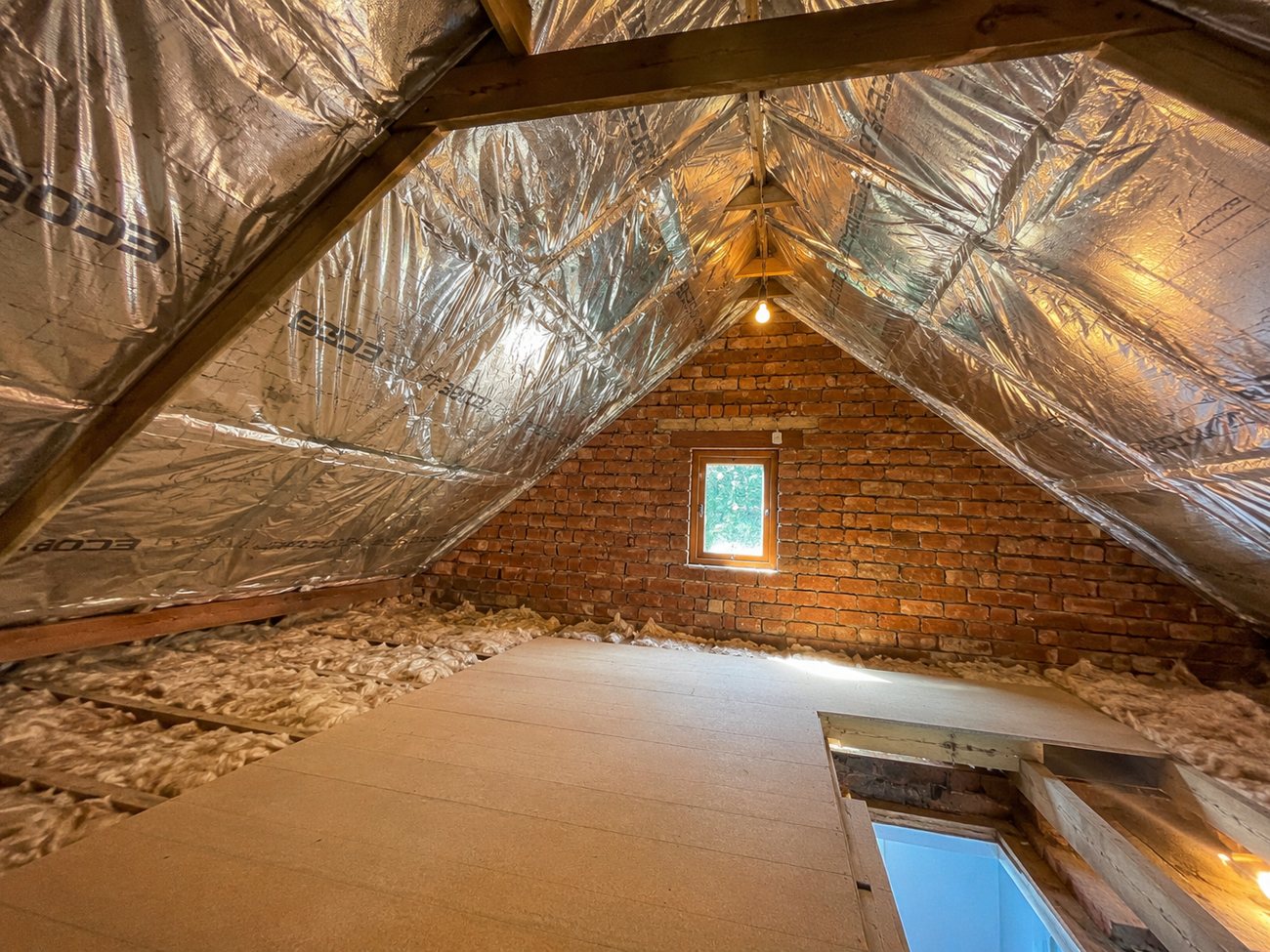 Completed loft with SF19 SuperFOIL across the roof pitch, mineral wool to the floor and raised boarding