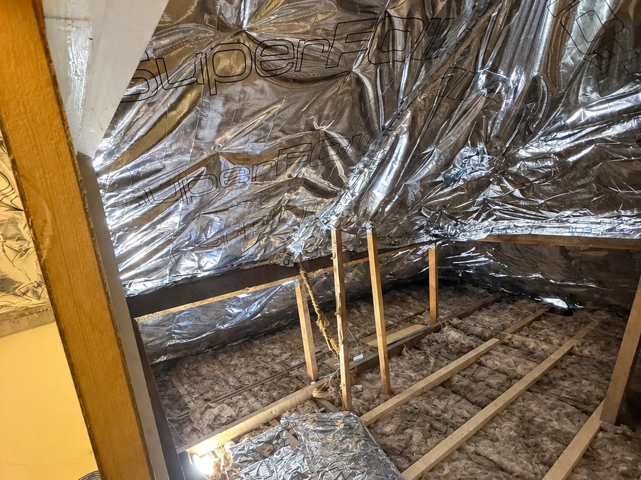 Removal and replacement of old fibre insulation in Bridgend farm loft