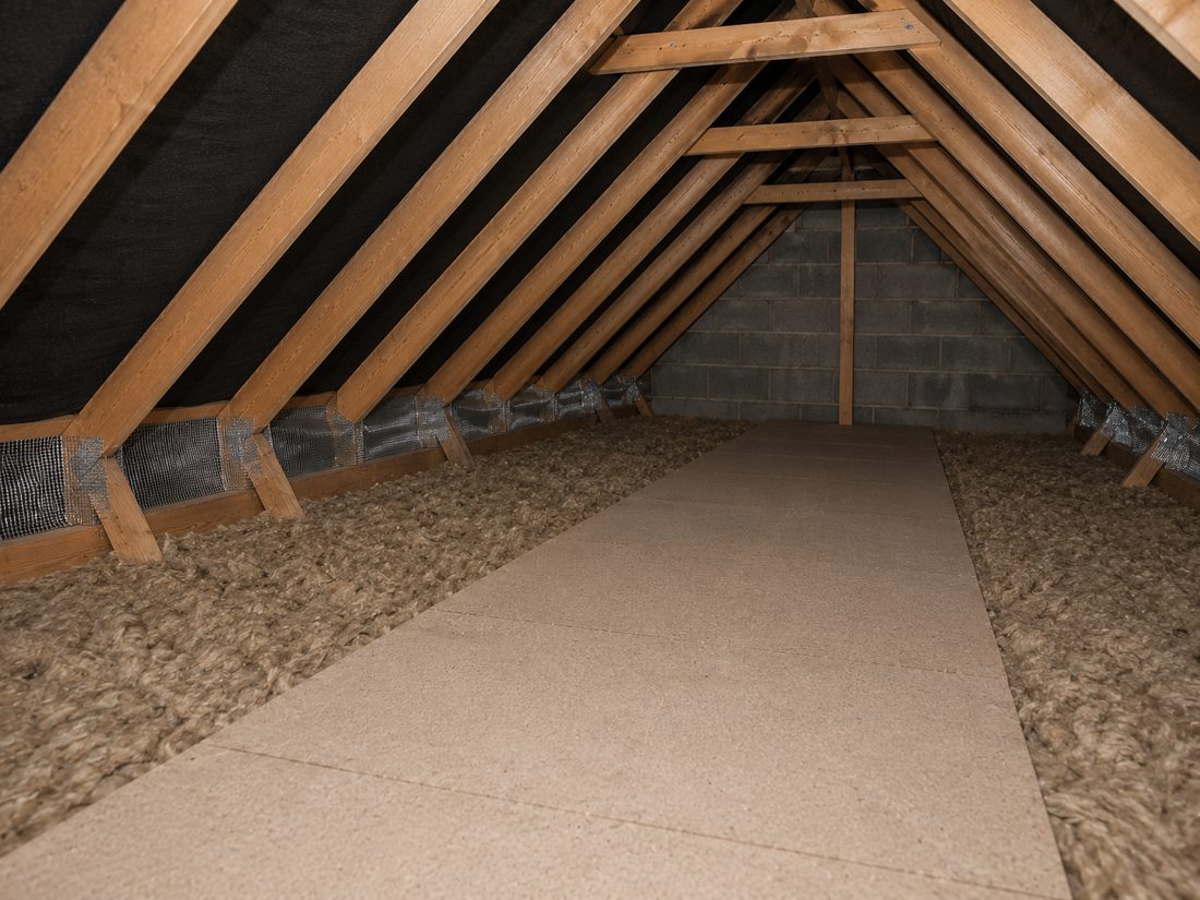 Contaminated loft insulation being removed and bagged